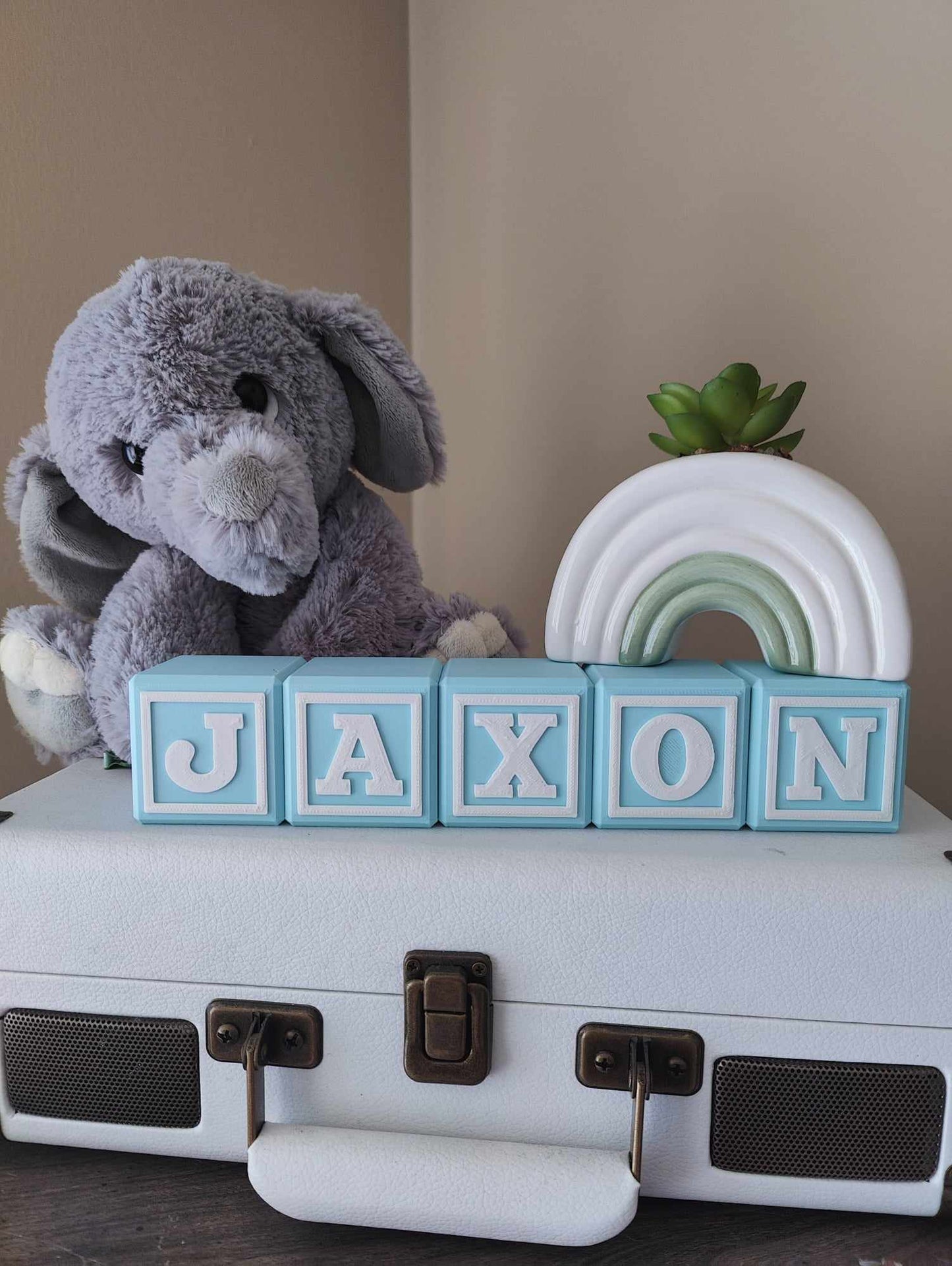 Baby blue personalized baby blocks spelling out the name Jaxon